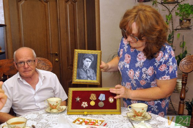 Світлана Володимирівна показує сімейні реліквії: фронтове фото та нагороди Олексія Даниловича Ваймана
