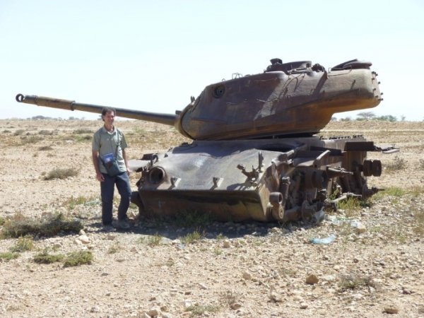 24. Майк Спенсер Боун в Сомалі на фоні рожевого остова американського танка. Фото: Mike Spencer Bown / SWNS