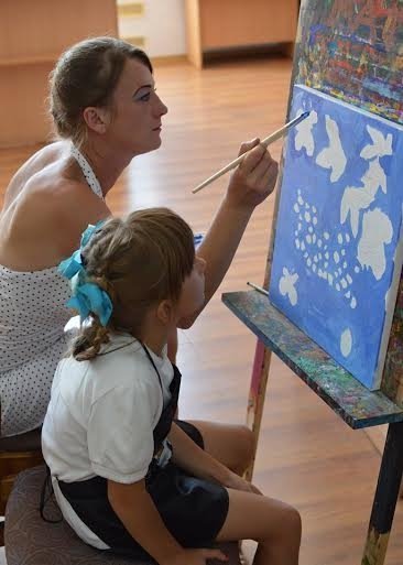 У Луцьку дружини учасників АТО та їхні дітки малювали картини «Під покровом любові». ФОТО