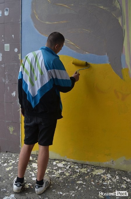 Луцький райтер в центрі міста пише нове графіті. ФОТО