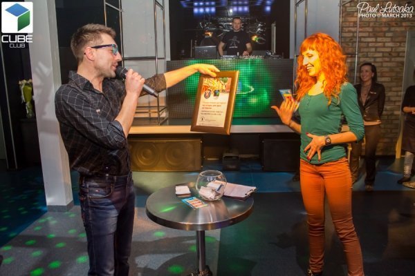 Ведучий вечірки вручає путівку щасливиці - Юлії Лампіній